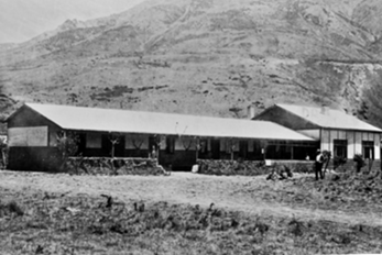 A picture containing outdoor, mountain, grass, barn

Description automatically generated