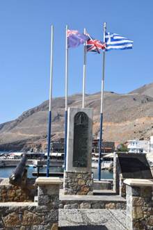A stone monument with flags

Description automatically generated
