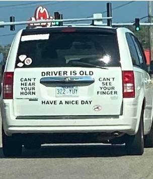 A white car with stickers on the back

Description automatically generated